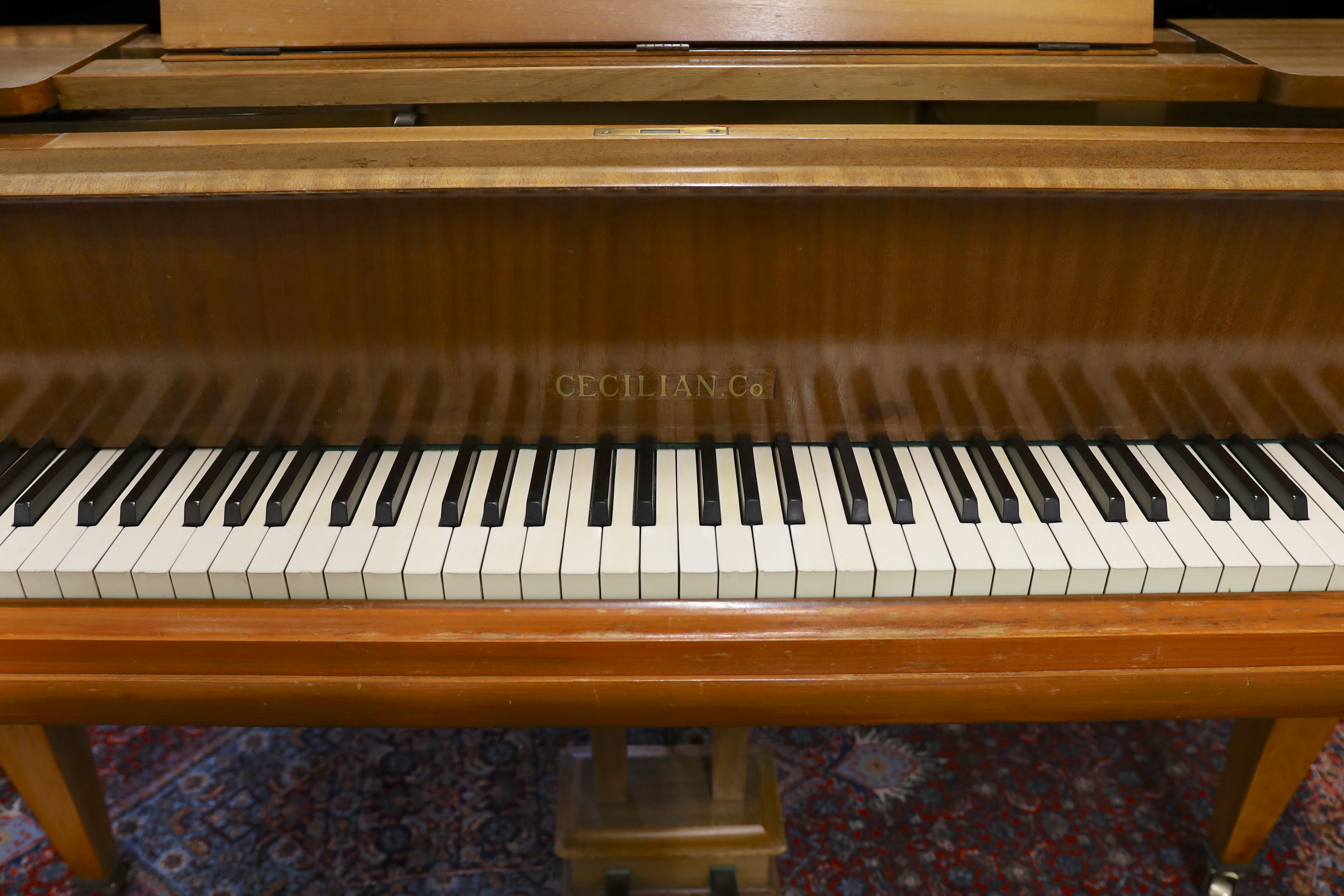 A mid 20th Cecilian & Co mahogany baby grand piano retailed by Harrods Ltd